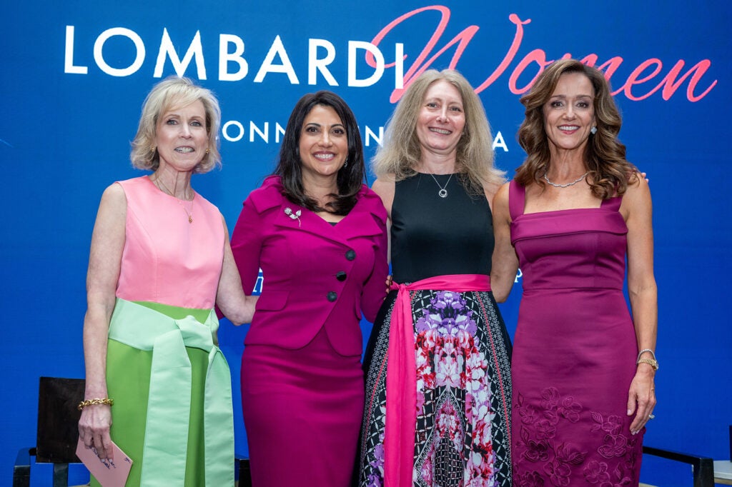 Four women stand together